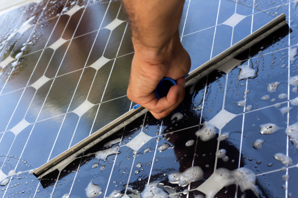 Image of a solar panel being cleaned