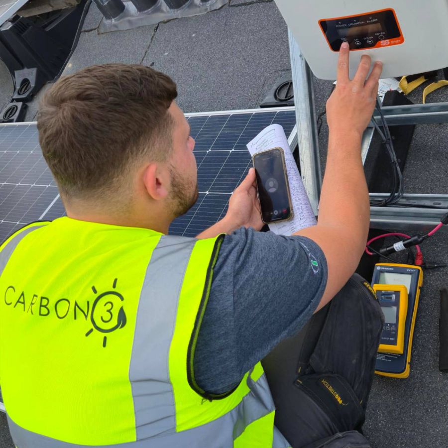 Engineers installing renewable energy systems on a secure defence site